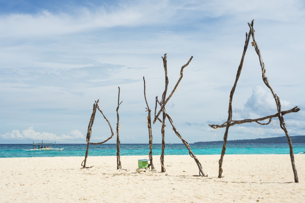Puka beach in Boracay, white sand and blue water, with the work